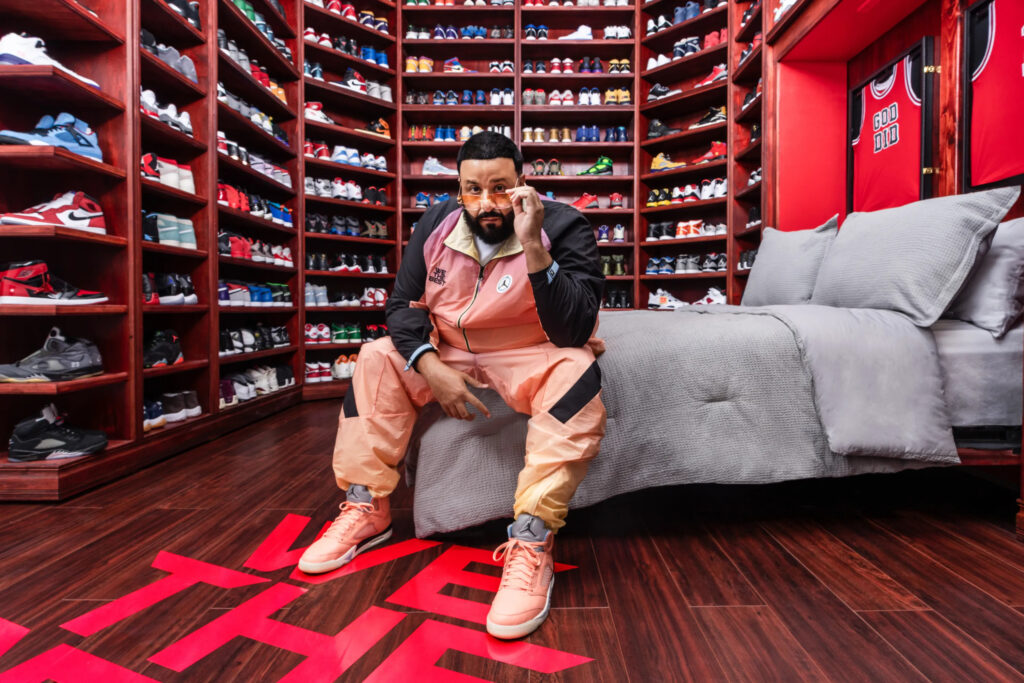 The Most Expensive Sneakers in the World, sneaker collector sitting in a luxury sneaker room surrounded by floor to ceiling shelves filled with rare and colorful sneakers
