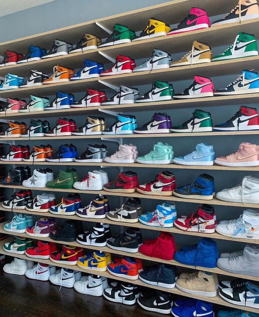 The Most Expensive Sneakers in the World, wall-mounted shelves packed with colorful rare high-top sneakers arranged like a collector’s display