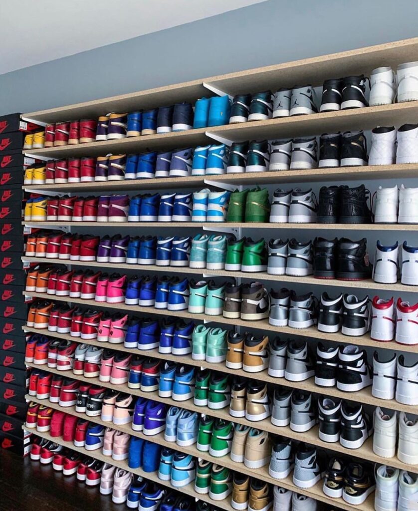 The Most Expensive Sneakers in the World, organized sneaker wall with dozens of rare pairs lined up on long shelves in a collector’s room