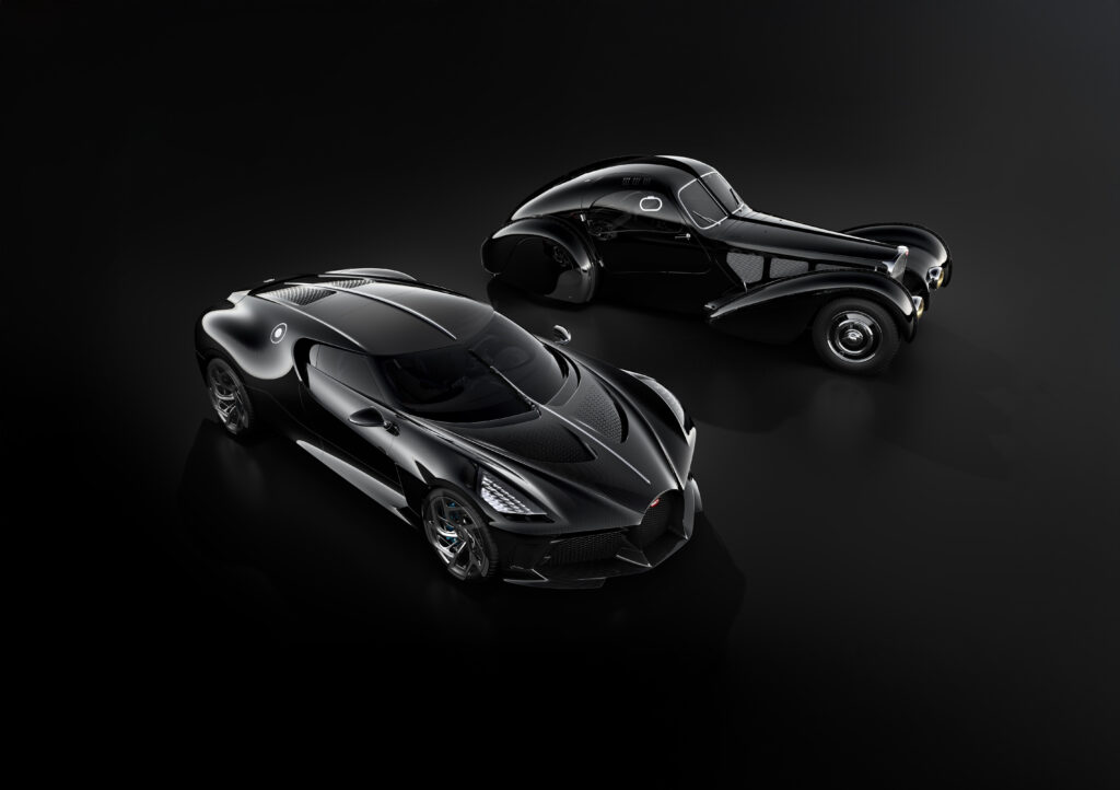 Most expensive car in the world, modern black Bugatti La Voiture Noire parked beside classic Bugatti coupe on glossy dark studio background